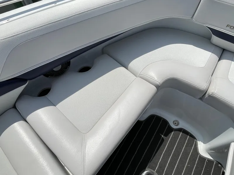 Slide: The Image of 2014 Formula 270 Bowrider interior seating with gray upholstery and cup holders. - 10