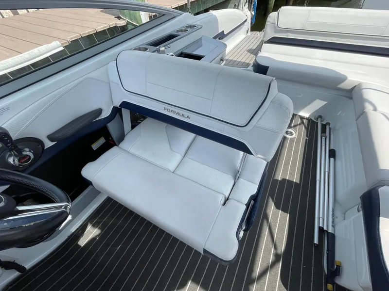 Slide: The Image of Interior of a 2014 Formula 270 Bowrider boat with white seating and striped flooring. - 19