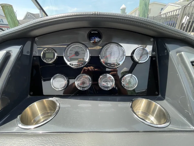 Slide: The Image of Dashboard of a 2014 Formula 270 Bowrider boat with gauges and cup holders. - 23