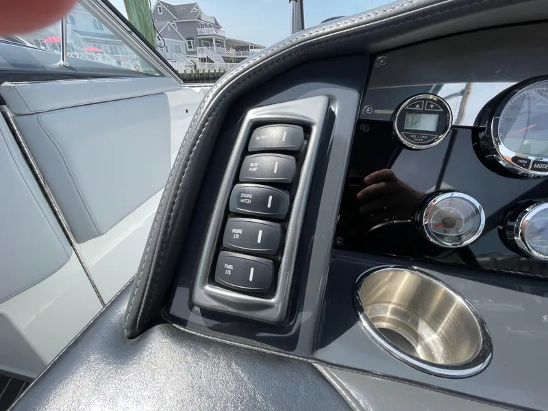 Slide: The Image of Dashboard controls of a 2014 Formula 270 Bowrider boat, featuring switches and gauges. - 24