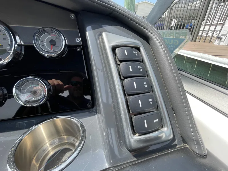 Slide: The Image of Dashboard controls of a 2014 Formula 270 Bowrider boat with gauges and switches. - 25