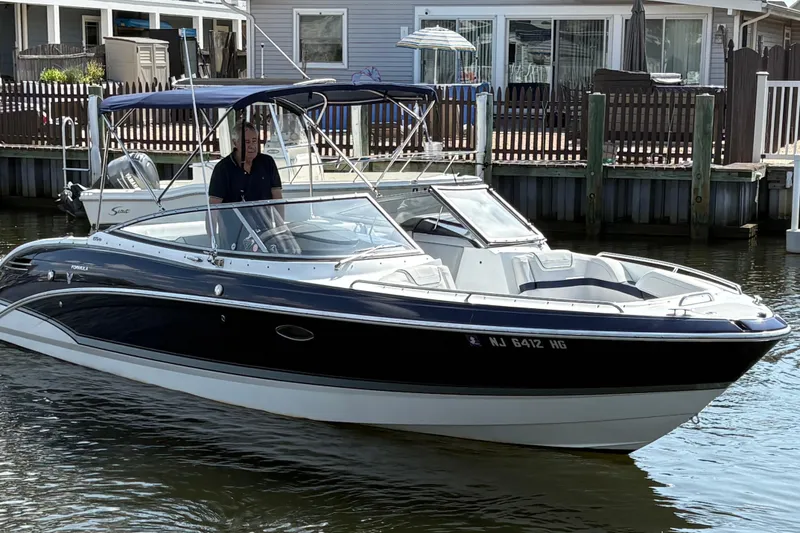 Slide: The Image of 2014 Formula 270 Bowrider boat docked near waterfront homes. - 3