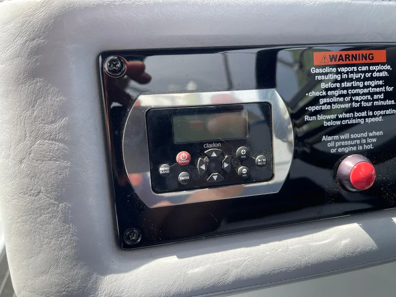 Slide: The Image of Control panel of a 2014 Formula 270 Bowrider with warning label and Clarion audio system. - 31