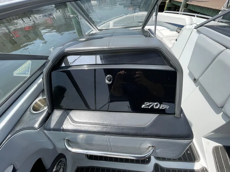 Slide: The Image of 2014 Formula 270 Bowrider interior with sleek black dashboard and seating. - 33