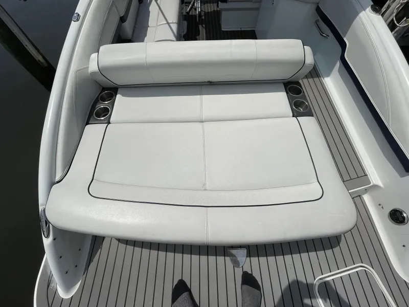 Slide: The Image of 2014 Formula 270 Bowrider boat with white cushioned seating and cup holders. - 44