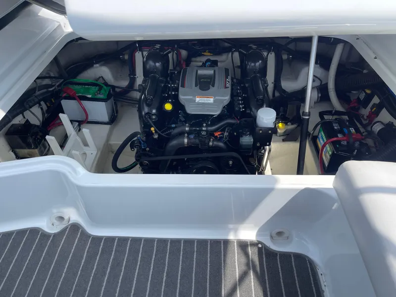 Slide: The Image of Engine compartment of a 2014 Formula 270 Bowrider boat, showcasing the engine and battery setup. - 48