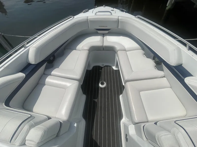 Slide: The Image of 2014 Formula 270 Bowrider boat interior with white seating and sleek design. - 8