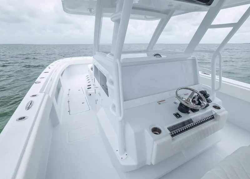 Slide: The Image of 2026 Invincible 40 Catamaran, sleek white design, open sea view, modern helm station. - 14