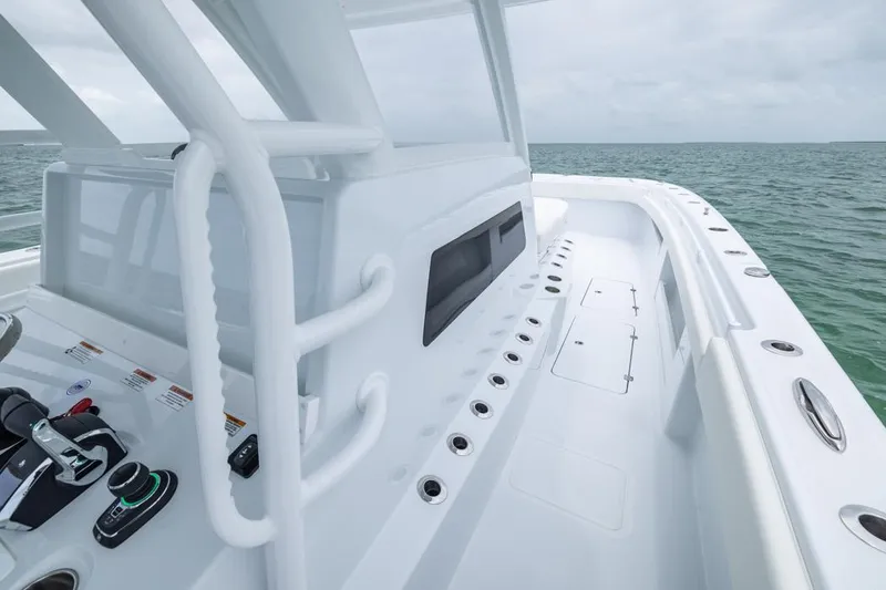 Slide: The Image of 2026 Invincible 40 Catamaran deck with modern controls, cruising on open water. - 15