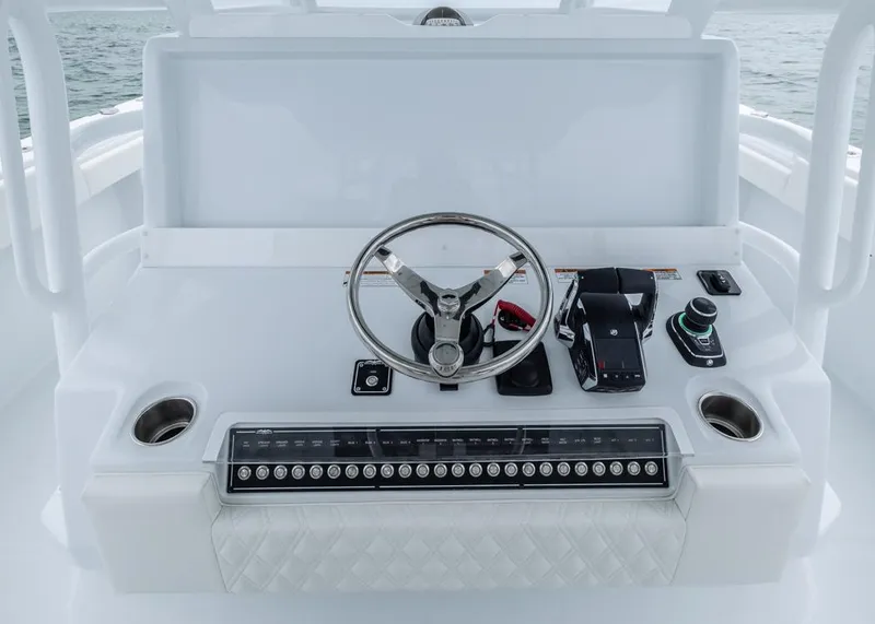 Slide: The Image of Helm of 2026 Invincible 40 Catamaran with steering wheel and controls. - 16