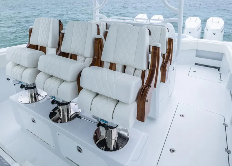 Slide: The Image of Luxurious seating on 2026 Invincible 40 Catamaran, featuring white leather and wood accents. - 17