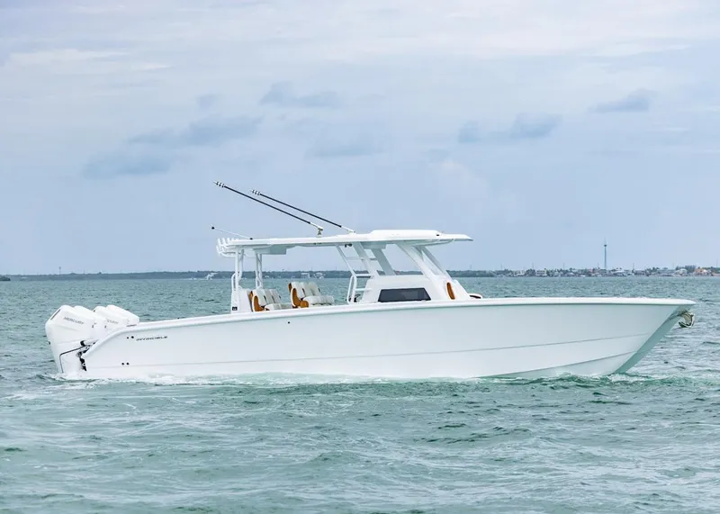 Slide: The Image of 2026 Invincible 40 Catamaran cruising on open water, showcasing sleek design and powerful engines. - 2