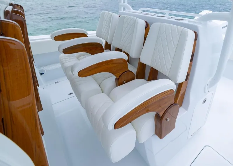 Slide: The Image of Luxurious seating on 2026 Invincible 40 Catamaran with white cushions and wooden accents. - 20