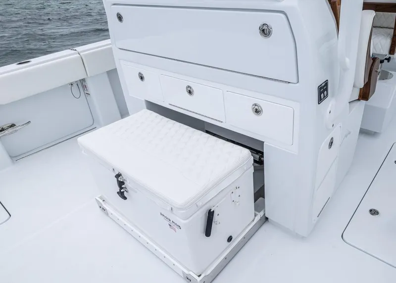 Slide: The Image of Invincible 40 Catamaran 2026 interior with storage drawers and cushioned cooler seat. - 25
