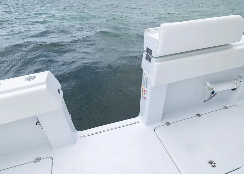 Slide: The Image of 2026 Invincible 40 Catamaran deck with ocean view, featuring white seating and storage. - 28