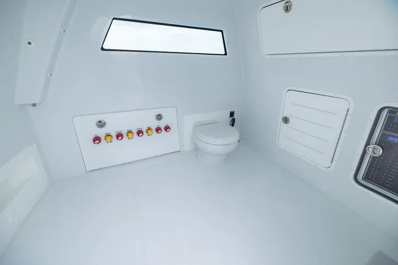 Slide: The Image of Interior of 2026 Invincible 40 Catamaran featuring a modern marine toilet and control panel. - 29