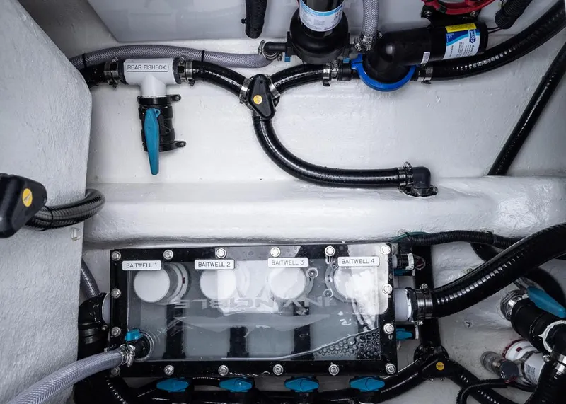 Slide: The Image of Engine compartment of 2026 Invincible 40 Catamaran with baitwell system and plumbing. - 34