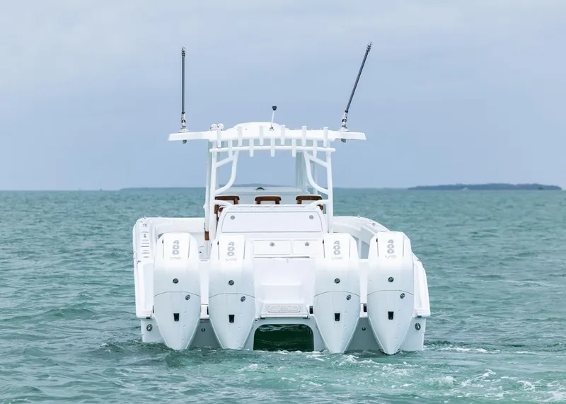 Slide: The Image of Invincible 40 Catamaran 2026 on open water, rear view with four engines. - 37