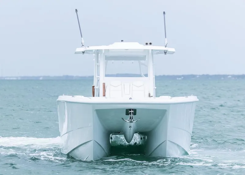Slide: The Image of 2026 Invincible 40 Catamaran cruising on open water, front view. - 38