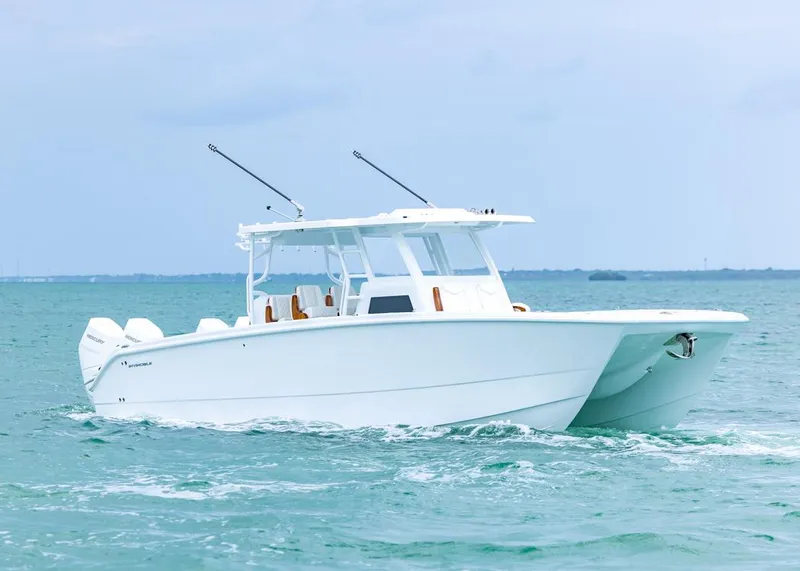 Slide: The Image of 2026 Invincible 40 Catamaran cruising on open water, showcasing sleek design and powerful engines. - 4