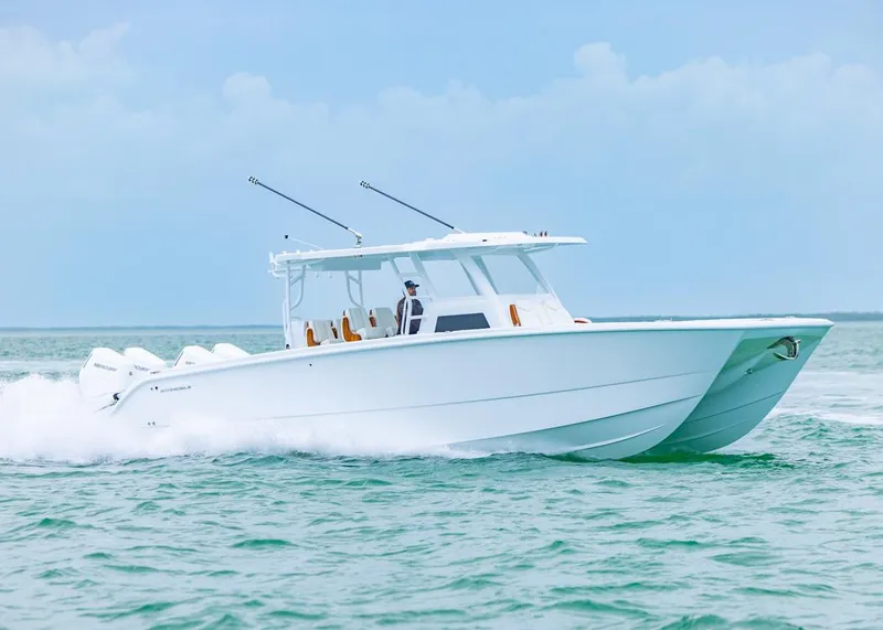 Slide: The Image of 2026 Invincible 40 Catamaran cruising on open water, showcasing sleek design and powerful engines. - 40