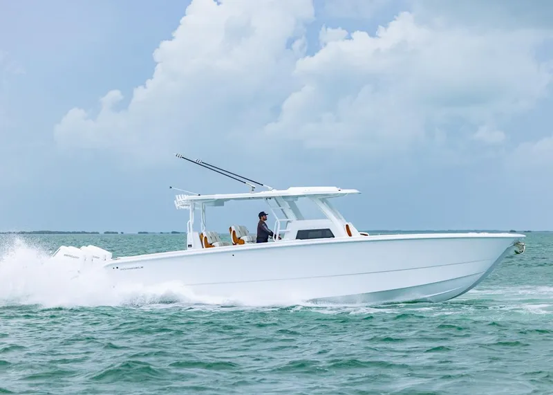 Slide: The Image of 2026 Invincible 40 Catamaran cruising on open water under a cloudy sky. - 41