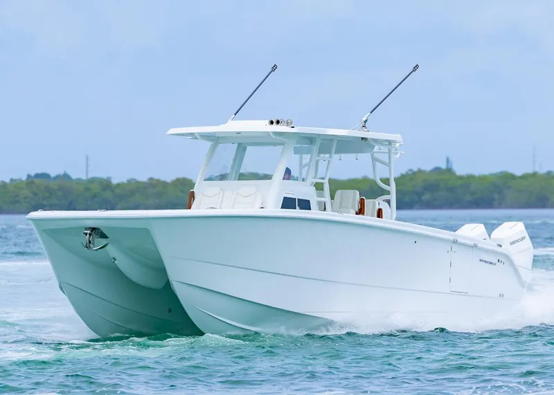 Slide: The Image of 2026 Invincible 40 Catamaran cruising on water, showcasing sleek design and powerful engines. - 43