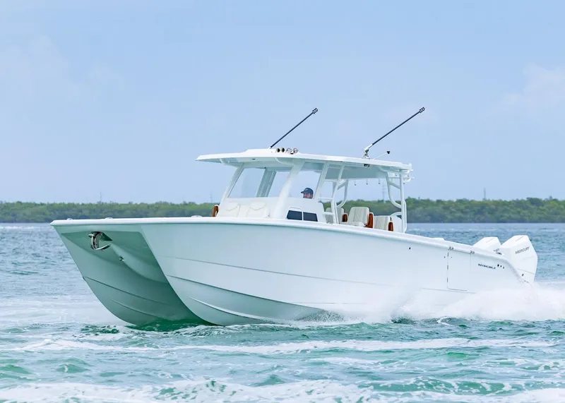 Slide: The Image of 2026 Invincible 40 Catamaran cruising on open water, showcasing sleek design and performance. - 44