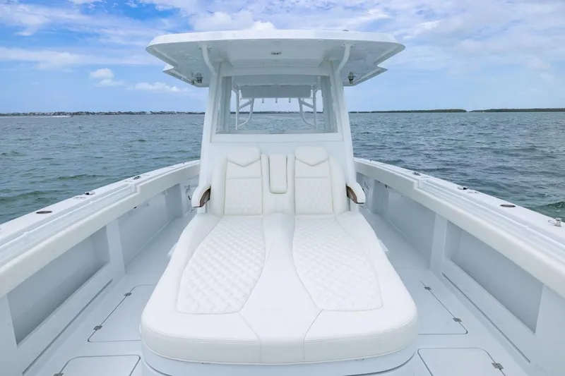 Slide: The Image of Invincible 40 Catamaran 2026 with luxurious white seating on open water. - 7