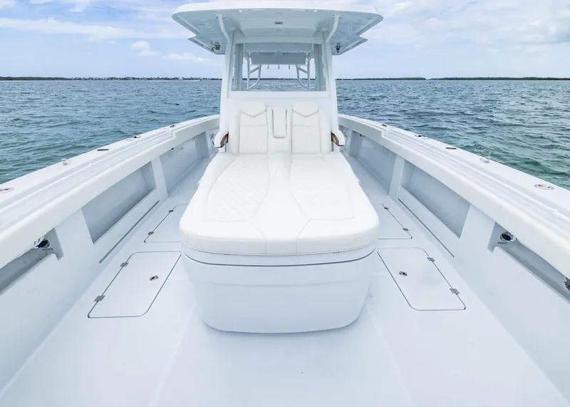 Slide: The Image of 2026 Invincible 40 Catamaran with white seating, cruising on open water. - 8