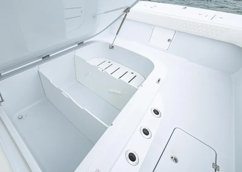 Slide: The Image of Spacious storage compartment on 2026 Invincible 40 Catamaran, featuring sleek white design and secure latches. - 9