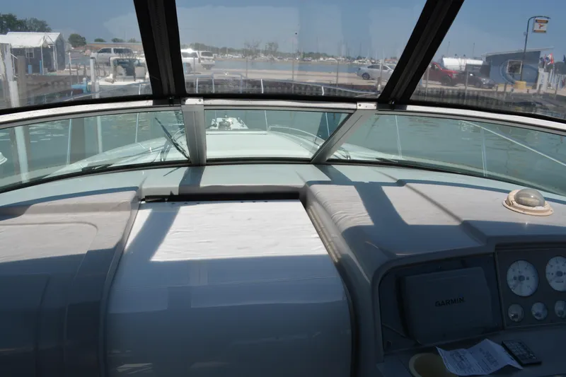 Slide: The Image of 1998 Formula 31 PC boat cockpit view with dashboard and marina background. - 10