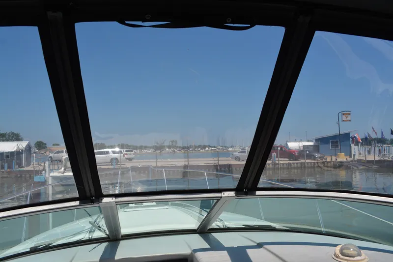 Slide: The Image of View from a 1998 Formula 31 PC boat docked at a marina on a sunny day. - 11