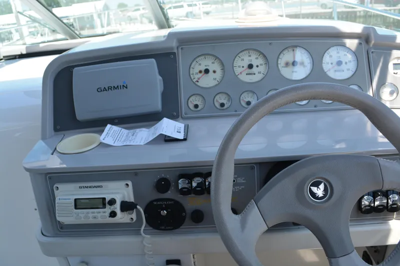 Slide: The Image of 1998 Formula 31 PC boat dashboard with Garmin GPS and control instruments. - 12