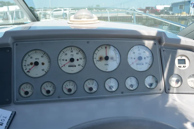 Slide: The Image of Dashboard of a 1998 Formula 31 PC boat with various gauges and controls. - 14