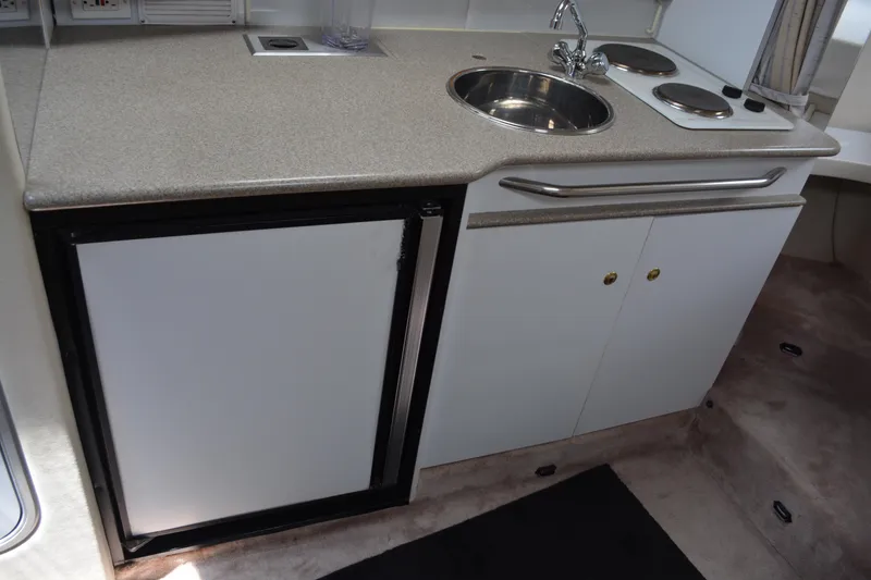 Slide: The Image of 1998 Formula 31 PC boat kitchenette with sink, stove, and mini fridge. - 19