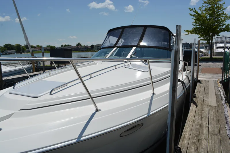 Slide: The Image of 1998 Formula 31 PC boat docked at marina under clear blue sky. - 2