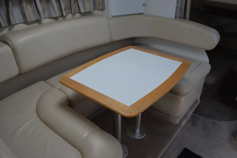 Slide: The Image of 1998 Formula 31 PC interior with beige leather seating and wooden table. - 24