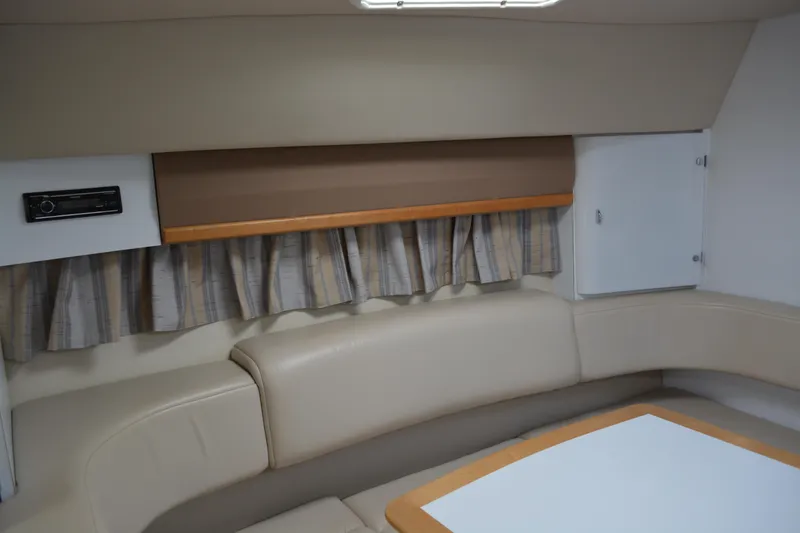 Slide: The Image of 1998 Formula 31 PC cabin interior with beige seating and curtains. - 25