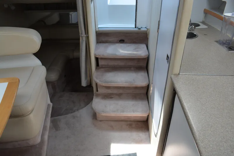 Slide: The Image of Interior of 1998 Formula 31 PC yacht with carpeted stairs and seating area. - 28