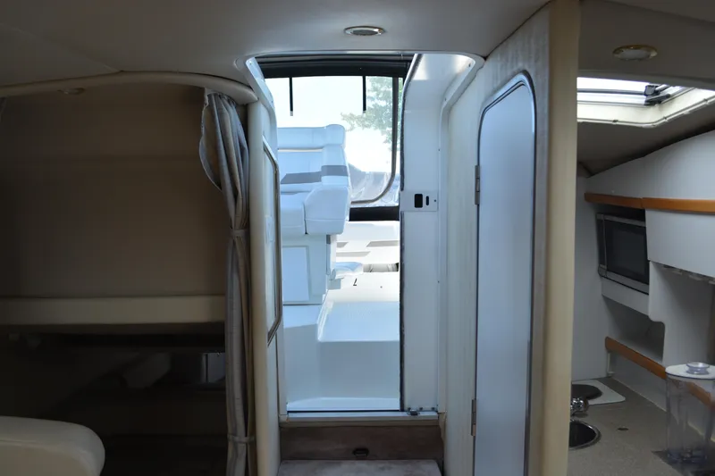 Slide: The Image of Interior view of a 1998 Formula 31 PC boat, featuring seating and a kitchenette. - 29