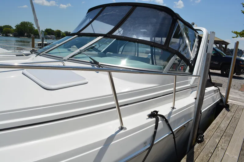 Slide: The Image of 1998 Formula 31 PC boat docked, featuring sleek design and clear canopy. - 3