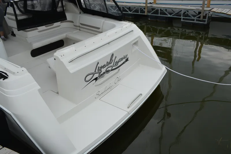 Slide: The Image of 1998 Formula 31 PC boat docked, featuring spacious seating and elegant design. - 33