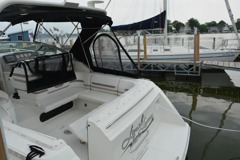 Slide: The Image of 1998 Formula 31 PC boat docked at marina, featuring spacious seating and sleek design. - 34