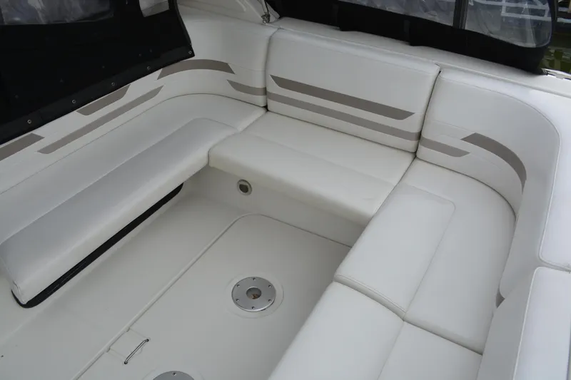 Slide: The Image of 1998 Formula 31 PC boat interior with white cushioned seating. - 36