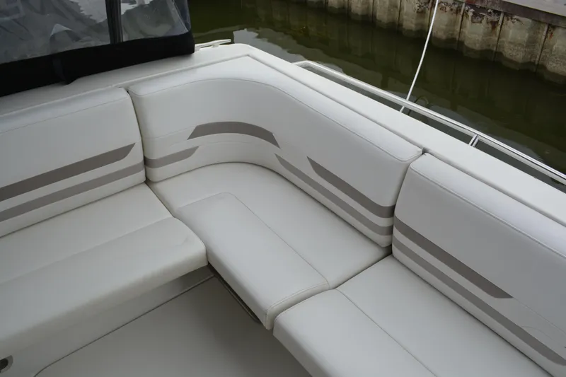 Slide: The Image of 1998 Formula 31 PC boat with white cushioned seating and striped design. - 37
