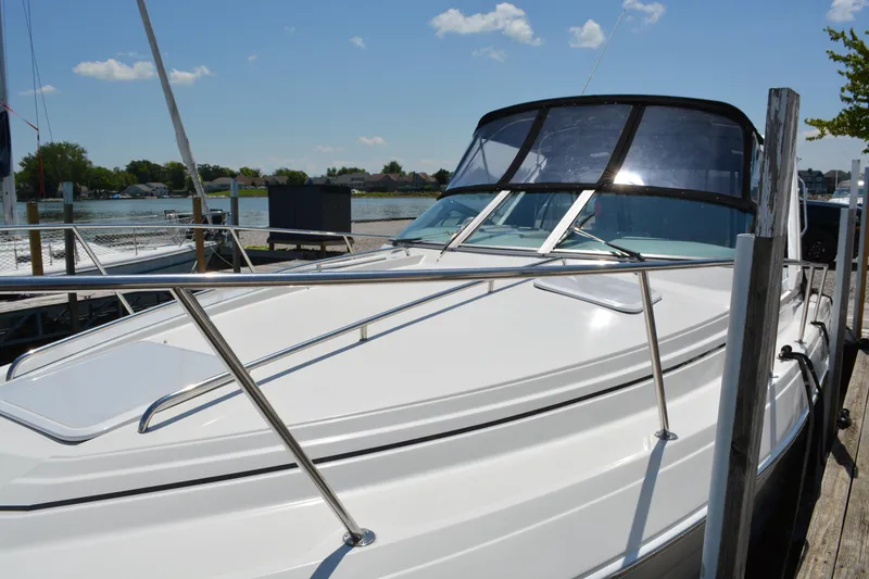 Slide: The Image of 1998 Formula 31 PC boat docked by the water on a sunny day. - 4