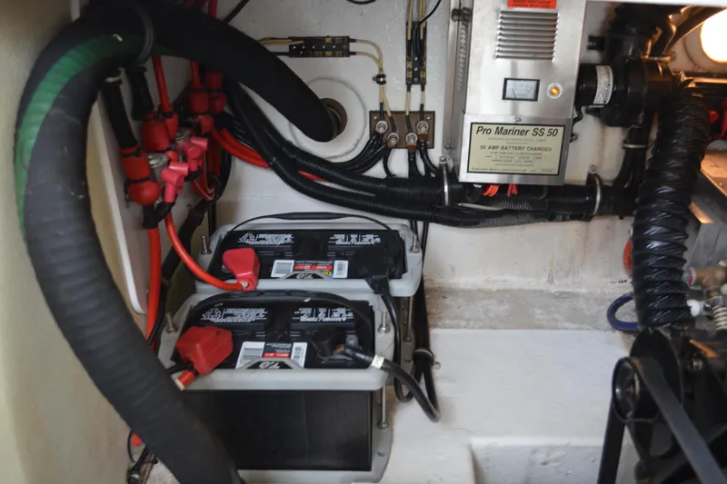 Slide: The Image of Engine compartment of 1998 Formula 31 PC with batteries and Pro Mariner SS 50 charger. - 42