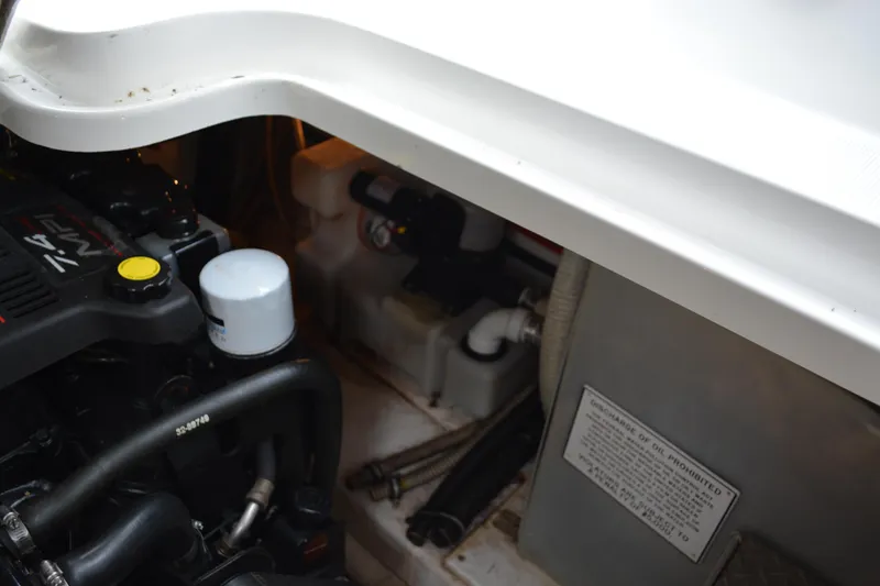 Slide: The Image of Engine compartment of a 1998 Formula 31 PC boat, showing mechanical components and labels. - 46