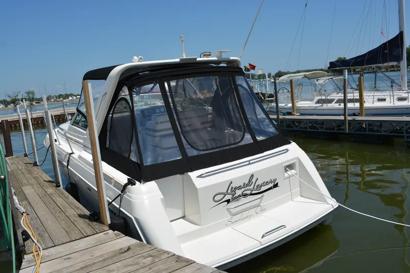 Slide: The Image of 1998 Formula 31 PC boat docked at marina, rear view with canopy. - 5